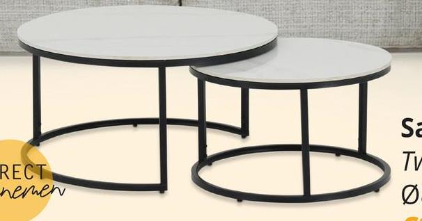 Salontafel Set van 2 TWINNY Wit Ontdek de perfecte aanvulling voor jouw woonruimte met onze salontafel set TWINNY! Deze set bestaat uit twee prachtige ronde salontafels, ontworpen om jouw interieur te verfraaien en functionaliteit toe te voegen.De kleinere tafel, met een diameter van 60 cm en een hoogte van 37 cm, past perfect bij de grotere tafel, die een diameter heeft van 80 cm en een hoogte van 41 cm. Samen creëren ze een dynamisch duo dat jouw woonkamer naar een hoger niveau tilt.Beide tafels zijn vervaardigd uit gesinterd wit, wat zorgt voor duurzaamheid en een moderne uitstraling. Het strakke en eigentijdse ontwerp wordt versterkt door de zwarte onderstellen, die niet alleen stabiliteit bieden, maar ook een vleugje elegantie toevoegen aan het geheel.